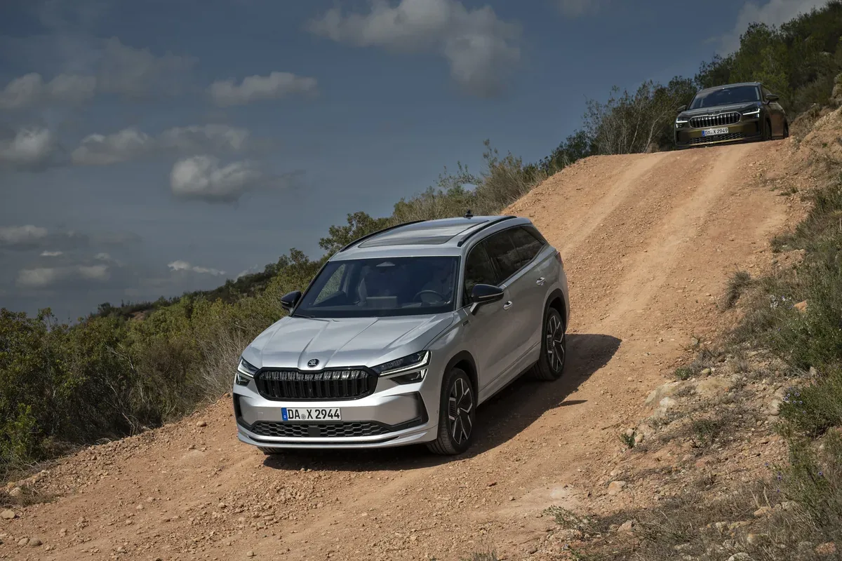 Silver Skoda Kodiaq driving down a rocky off-road track