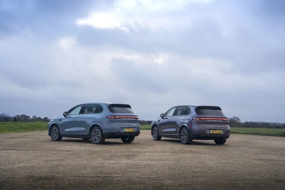 Two grey Leapmotor B10 SUVs parked on open tarmac beneath cloudy skies