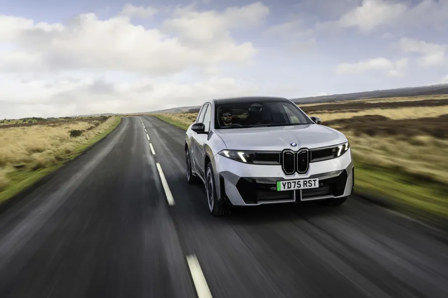 Electric SUV in silver driving on an open road