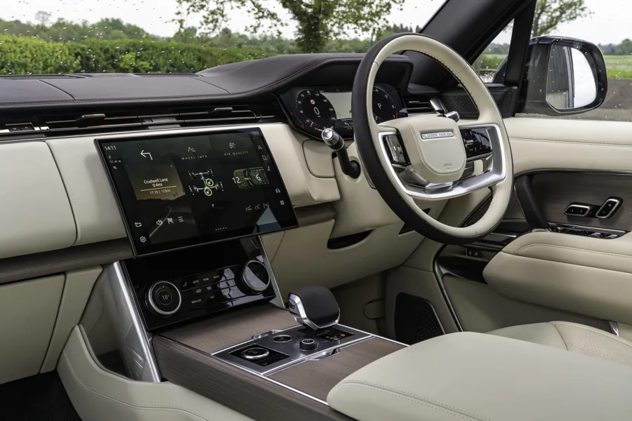 Range Rover interior with cream leather, curved touchscreen and woodgrain console