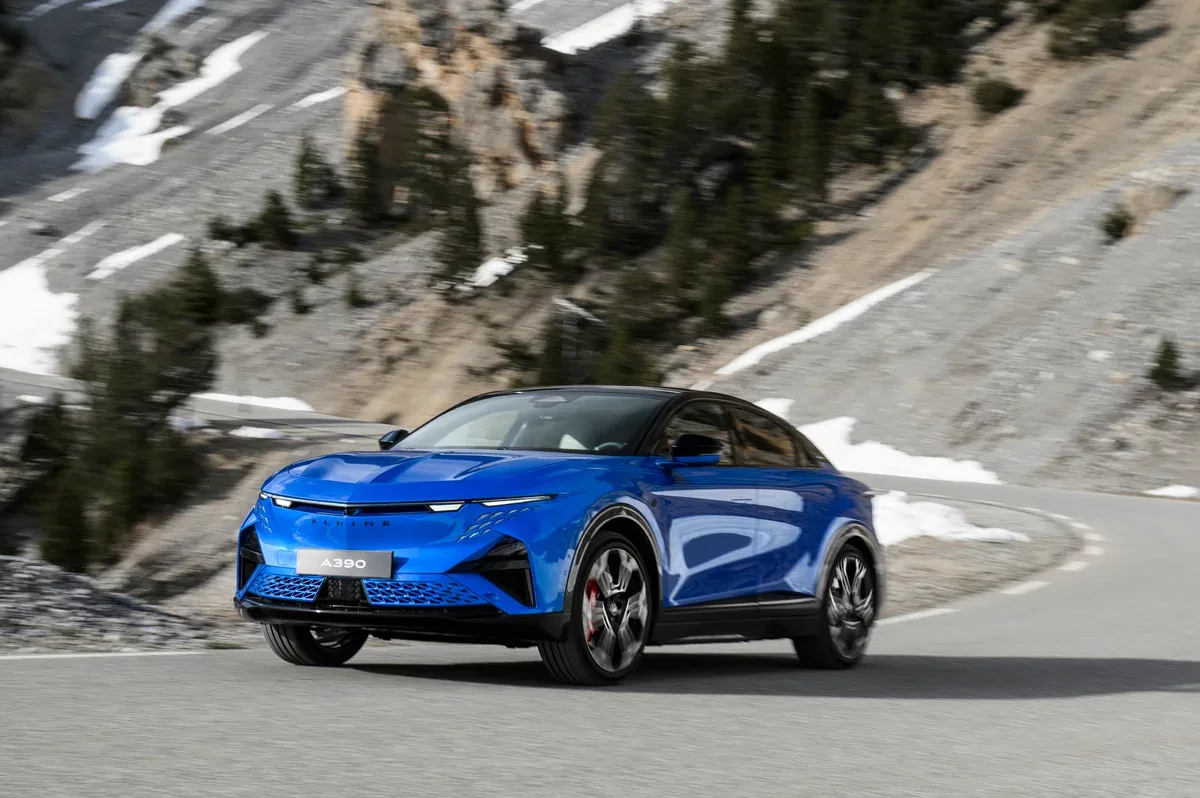 Blue Alpine A390 GTS driving on an Alpine mountain road