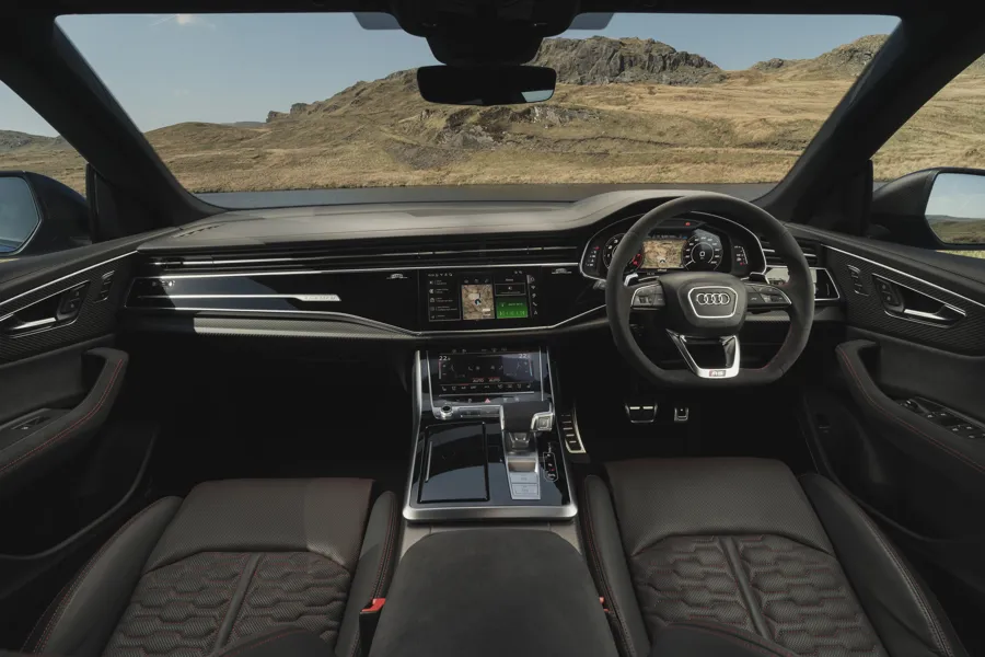 Audi Q8 RS interior with black leather and red stitching, flat-bottom steering wheel and twin touchscreens